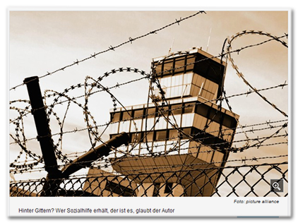 [Ein Turm, davor ein Zaun mit Stacheldraht.] Bildunterschrift: 'Hinter Gittern? Wer Sozialhilfe erhält, der ist es, glaubt der Autor'